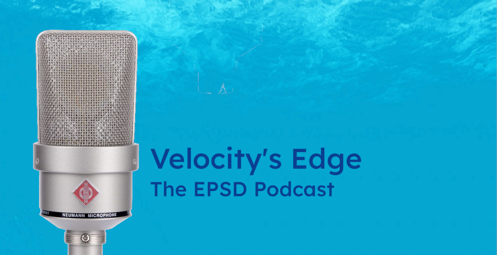 A Neumann TLM 103 microphone in front of a wave of water to illustrate recording the Velocity's Edge podcast